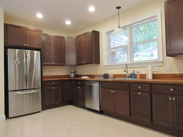 101 Bundy Hill Rd, Holmes, NY 12531 - kitchen with stainless steel appliances, recessed lighting, dark brown cabinets, hanging light fixtures, and light tile patterned flooring