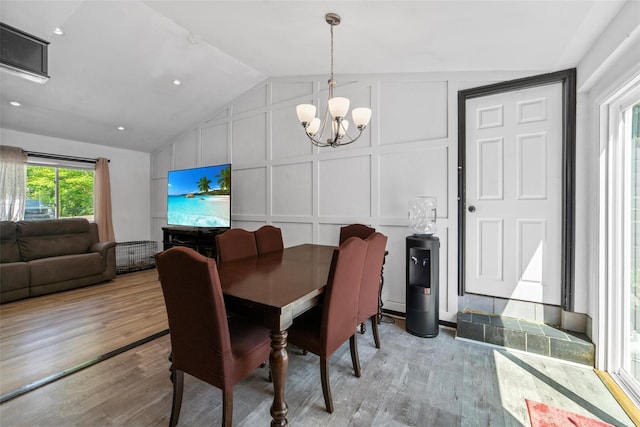 59 Oslo Dr, Yorktown Heights, NY 10598 - dining room with a decorative wall, a chandelier, lofted ceiling, and wood finished floors