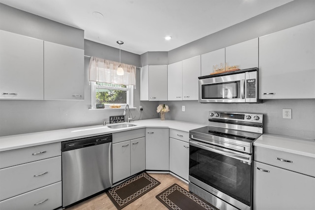 59 Oslo Dr, Yorktown Heights, NY 10598 - kitchen featuring appliances with stainless steel finishes, a sink, light wood-style flooring, light countertops, and recessed lighting