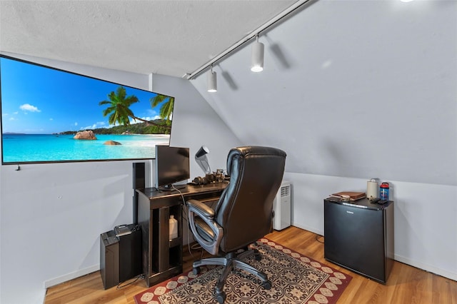 59 Oslo Dr, Yorktown Heights, NY 10598 - home office with track lighting, lofted ceiling, light wood-style flooring, baseboards, and a textured ceiling