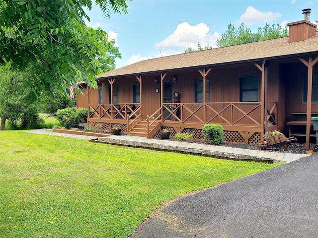 43 Last Rd, Montgomery, NY 10941 - ranch-style home featuring a porch, a front lawn, roof with shingles, and a chimney