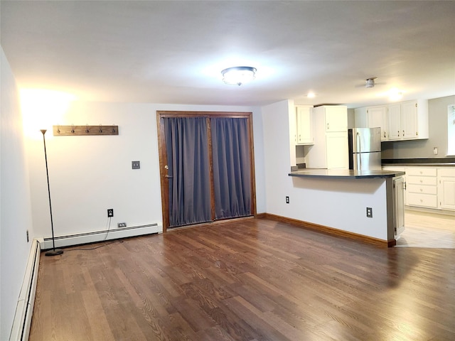 43 Last Rd, Montgomery, NY 10941 - kitchen featuring freestanding refrigerator, a baseboard radiator, dark countertops, wood finished floors, and a peninsula