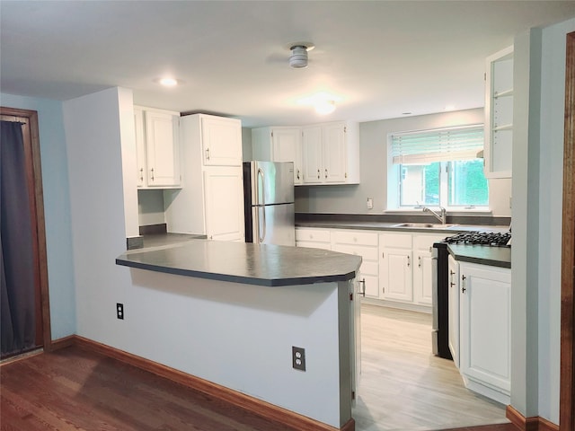 43 Last Rd, Montgomery, NY 10941 - kitchen with appliances with stainless steel finishes, dark countertops, light wood-style floors, a peninsula, and white cabinets