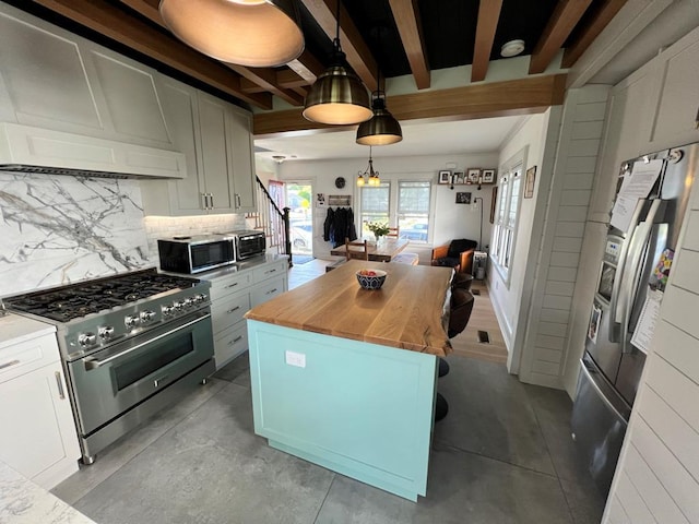 101 Oswego St, North Bellmore, NY 11710 - kitchen featuring stainless steel appliances, butcher block counters, tasteful backsplash, beam ceiling, and white cabinets