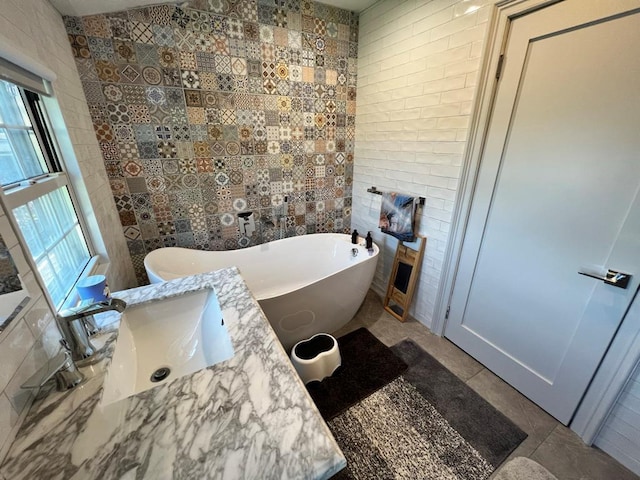 101 Oswego St, North Bellmore, NY 11710 - full bath featuring tile walls, a soaking tub, tile patterned flooring, a fireplace, and vanity