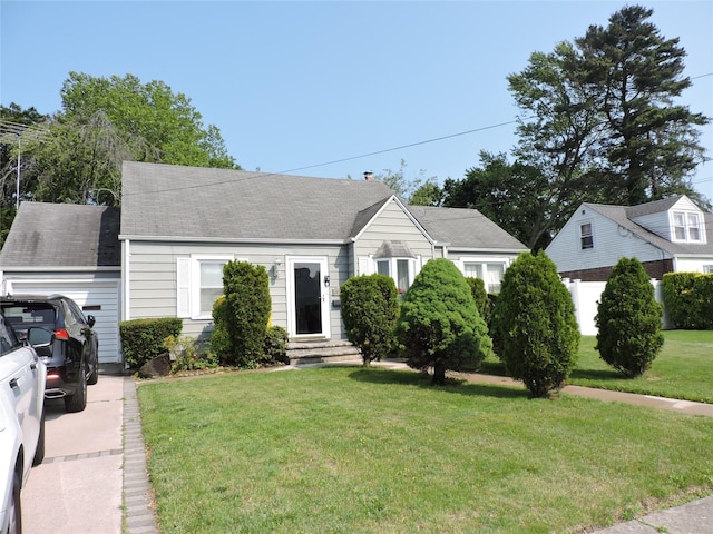 713 Colonial St, Uniondale, NY 11553 - view of front of home with a front yard, entry steps, a garage, and a shingled roof