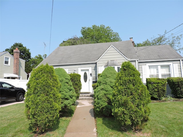 713 Colonial St, Uniondale, NY 11553 - view of front facade featuring a front yard and a shingled roof