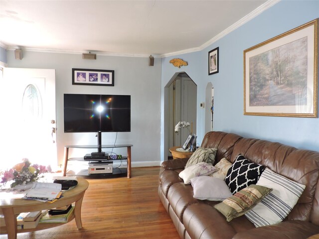 713 Colonial St, Uniondale, NY 11553 - living area with arched walkways, wood finished floors, crown molding, and baseboards