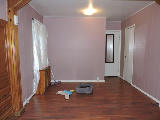 713 Colonial St, Uniondale, NY 11553 - empty room featuring wood finished floors, crown molding, baseboards, and wood walls