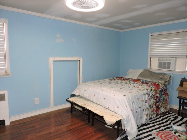 713 Colonial St, Uniondale, NY 11553 - bedroom featuring wood finished floors, radiator, ornamental molding, cooling unit, and baseboards