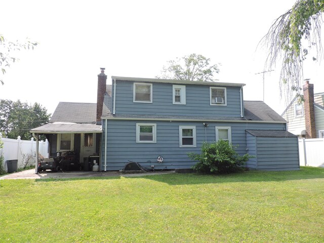 713 Colonial St, Uniondale, NY 11553 - back of house featuring a patio area, a chimney, and a shingled roof
