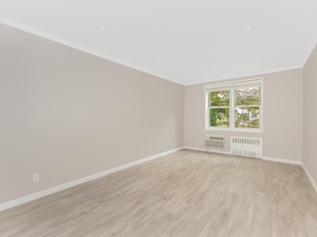 642 Locust St Unit 2D, Mount Vernon, NY 10552 - unfurnished room featuring radiator, baseboards, light wood-style floors, an AC wall unit, and crown molding