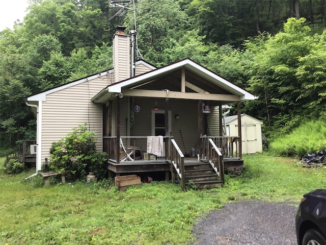 1814 Rte 199, Stanfordville, NY 12581 - view of front of property featuring a chimney, a forest view, a porch, and a front lawn