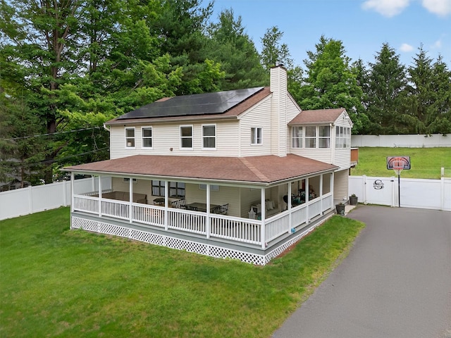 98 Greenhaven Rd, Poughquag, NY 12570 - farmhouse inspired home with a gate, roof mounted solar panels, a chimney, a sunroom, and a fenced backyard