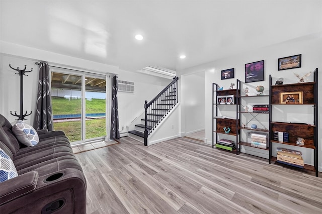 98 Greenhaven Rd, Poughquag, NY 12570 - living area featuring stairway, wood finished floors, recessed lighting, a wall mounted air conditioner, and baseboard heating