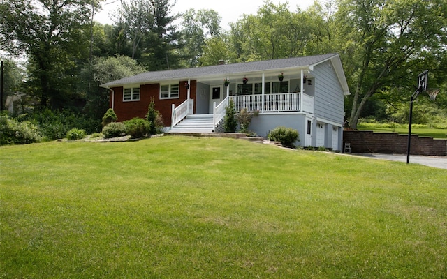 52 Old Chester Rd, Goshen, NY 10924 - view of front of house with covered porch, a garage, a front lawn, view of wooded area, and driveway