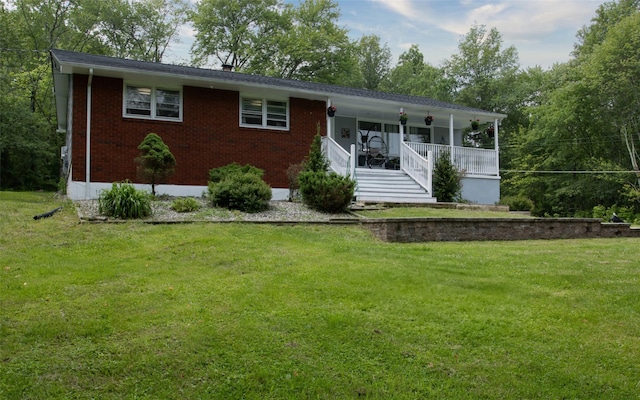52 Old Chester Rd, Goshen, NY 10924 - view of front of house with a front lawn, brick siding, and covered porch