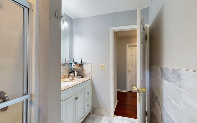 52 Old Chester Rd, Goshen, NY 10924 - bathroom featuring vanity, tile walls, and a shower with shower door