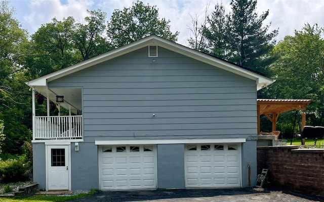 52 Old Chester Rd, Goshen, NY 10924 - view of side of home featuring an attached garage, asphalt driveway, and stucco siding