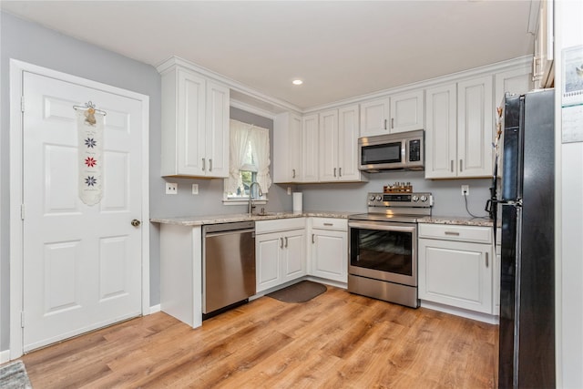 37 Old Mill Rd, Yorktown Heights, NY 10598 - kitchen featuring appliances with stainless steel finishes, light wood-style floors, white cabinetry, light stone counters, and recessed lighting