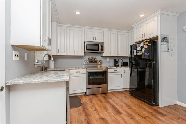 37 Old Mill Rd, Yorktown Heights, NY 10598 - kitchen featuring stainless steel appliances, light wood-style flooring, white cabinetry, light stone countertops, and recessed lighting