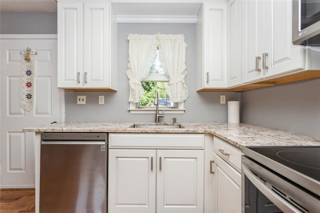 37 Old Mill Rd, Yorktown Heights, NY 10598 - kitchen featuring stainless steel appliances, white cabinets, ornamental molding, wood finished floors, and light stone counters
