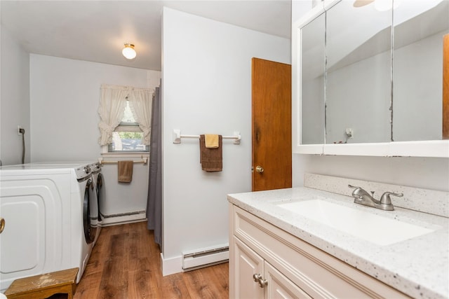 37 Old Mill Rd, Yorktown Heights, NY 10598 - laundry area featuring baseboard heating, washer and dryer, a baseboard radiator, and light wood-style flooring