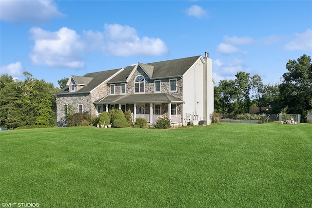 10 Wyllys Ct, Rock Tavern, NY 12575 - view of front facade with stone siding, a chimney, and a porch