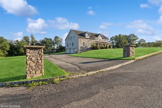 10 Wyllys Ct, Rock Tavern, NY 12575 - view of front of house with an attached garage, a front lawn, asphalt driveway, and stone siding