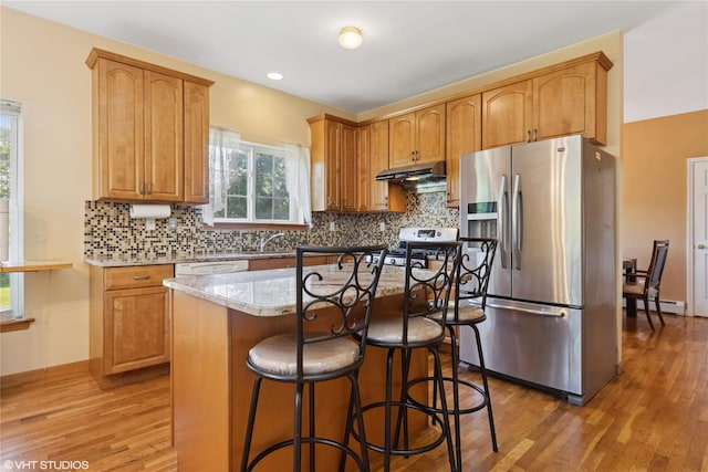 10 Wyllys Ct, Rock Tavern, NY 12575 - kitchen featuring stainless steel fridge with ice dispenser, a baseboard radiator, light wood-style flooring, and range