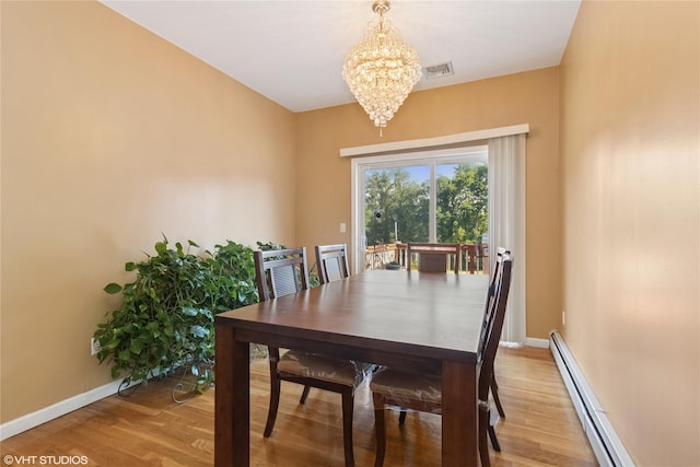 10 Wyllys Ct, Rock Tavern, NY 12575 - dining room with a baseboard heating unit, a chandelier, and light wood-style floors