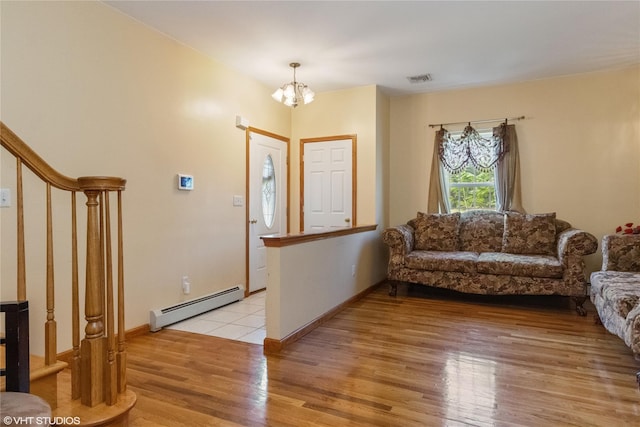 10 Wyllys Ct, Rock Tavern, NY 12575 - foyer entrance with a baseboard heating unit, a chandelier, and light wood finished floors