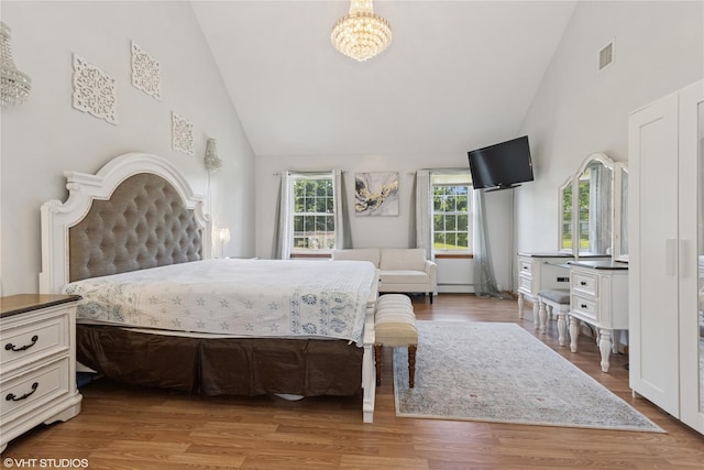 10 Wyllys Ct, Rock Tavern, NY 12575 - bedroom with high vaulted ceiling, a chandelier, and light wood-style floors
