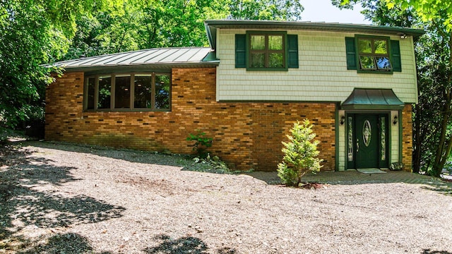 32 Overhill Rd, Yorktown Heights, NY 10598 - split level home featuring a standing seam roof, brick siding, and metal roof