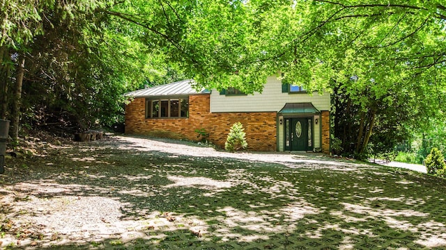 32 Overhill Rd, Yorktown Heights, NY 10598 - view of front of house with brick siding and a standing seam roof