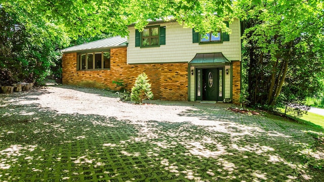 32 Overhill Rd, Yorktown Heights, NY 10598 - view of front of house featuring a standing seam roof, brick siding, and metal roof