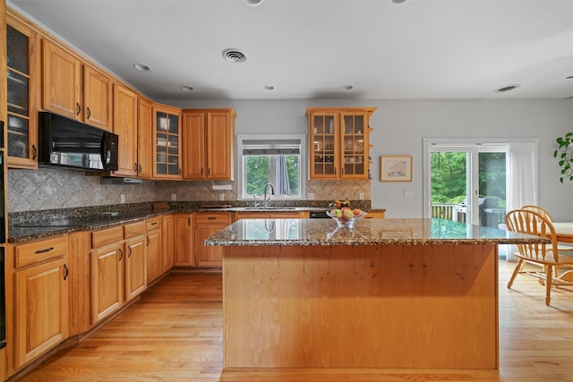 32 Woodcrest Ln, Goshen, NY 10924 - kitchen featuring a sink, black appliances, glass insert cabinets, light wood finished floors, and recessed lighting