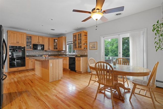 32 Woodcrest Ln, Goshen, NY 10924 - kitchen featuring black appliances, a sink, a kitchen island, tasteful backsplash, and light wood-style flooring