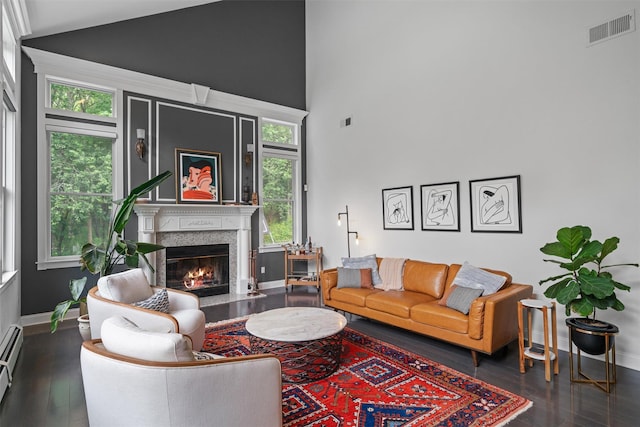 32 Woodcrest Ln, Goshen, NY 10924 - living area featuring high vaulted ceiling, baseboards, a fireplace, and wood-type flooring