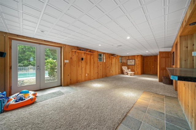 32 Woodcrest Ln, Goshen, NY 10924 - unfurnished living room featuring french doors, wooden walls, and recessed lighting