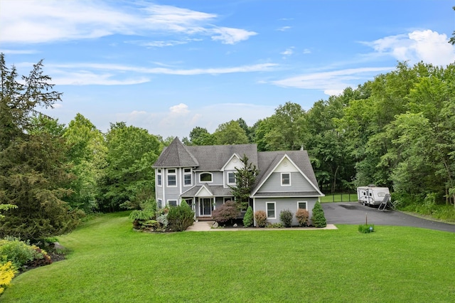 32 Woodcrest Ln, Goshen, NY 10924 - victorian-style house with a front yard, asphalt driveway, and a view of trees