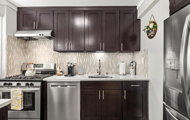 155-03 79th St Unit 188, Howard Beach, NY 11414 - kitchen with stainless steel appliances, under cabinet range hood, a sink, dark brown cabinets, and light countertops