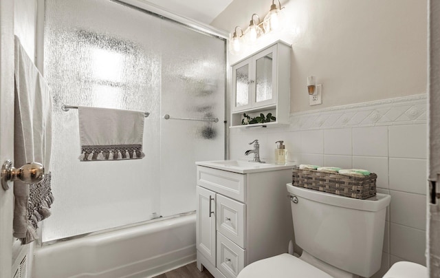 155-03 79th St Unit 188, Howard Beach, NY 11414 - full bath featuring toilet, vanity, bath / shower combo with glass door, a wainscoted wall, and tile walls