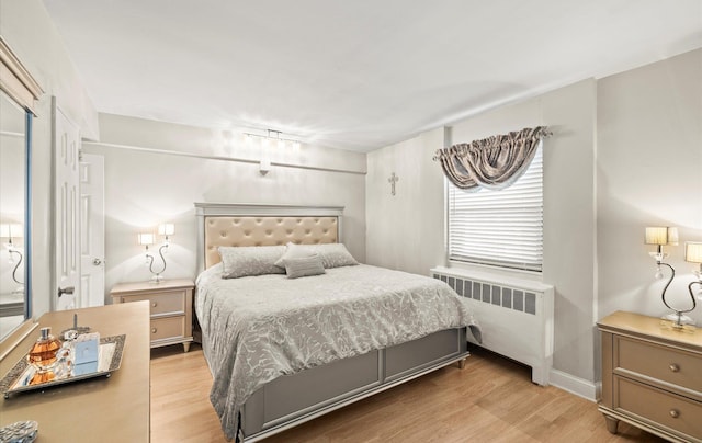 155-03 79th St Unit 188, Howard Beach, NY 11414 - bedroom featuring radiator heating unit and light wood-type flooring