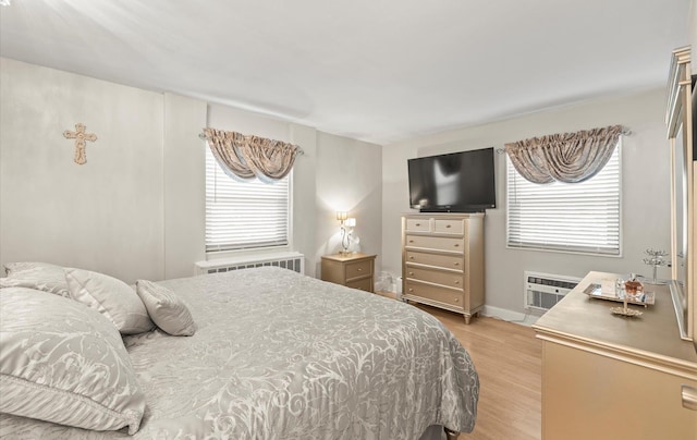 155-03 79th St Unit 188, Howard Beach, NY 11414 - bedroom featuring light wood finished floors, multiple windows, baseboards, and a wall mounted AC