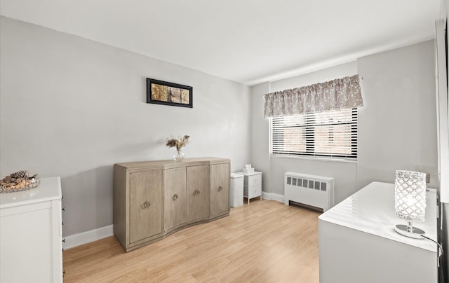 155-03 79th St Unit 188, Howard Beach, NY 11414 - bedroom with radiator heating unit, light wood-style flooring, and baseboards