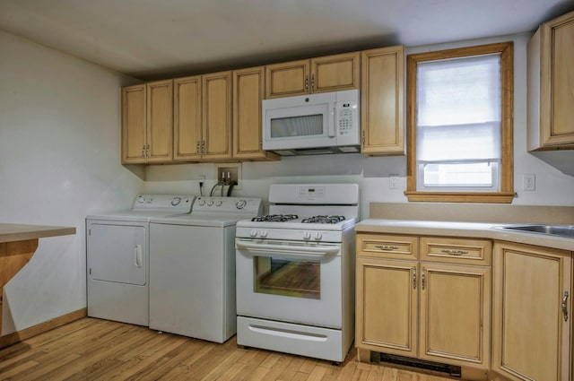 28 New Hampshire St, Long Beach, NY 11561 - kitchen featuring white appliances, washer and dryer, light countertops, and light wood finished floors