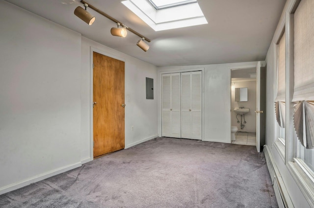 28 New Hampshire St, Long Beach, NY 11561 - unfurnished bedroom featuring a skylight, carpet flooring, electric panel, ensuite bathroom, and baseboards