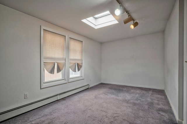 28 New Hampshire St, Long Beach, NY 11561 - spare room with baseboard heating, a skylight, track lighting, carpet floors, and baseboards