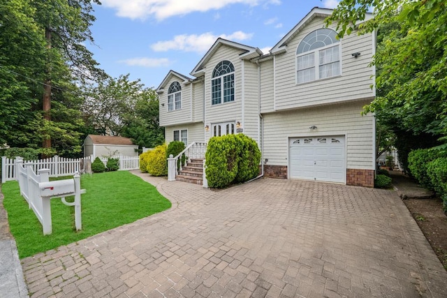 361 Locust Pl, Freeport, NY 11520 - view of front of property with an attached garage and decorative driveway